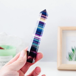 Handheld rainbow fluorite hexagonal crystal pillar with natural purple and green stripes