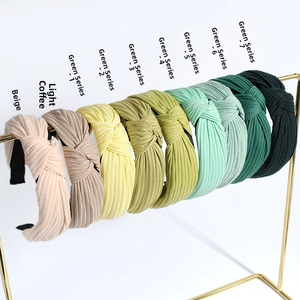 Macro detail of nine-color knotted cross headbands set with fine ribbed knit texture