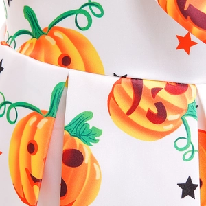 Detailed view of Jack-o'-lantern pumpkin print on white satin Halloween dress fabric