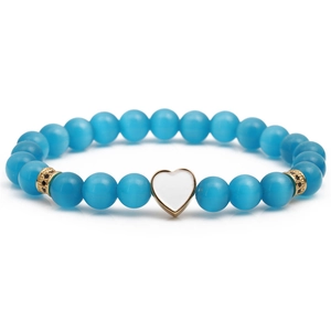 Lake blue cat eye beaded bracelet featuring a gold-plated white enamel heart charm