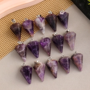 Natural faceted amethyst crystal point pendants with silver bail in a flat lay display