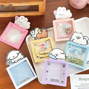 Flat lay of colorful cartoon animal jewelry boxes and hair accessories on a wooden desk