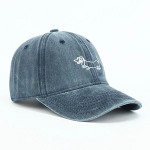 Detailed embroidery of a white dachshund on a navy blue washed denim baseball cap