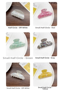 Detailed views of multi-colored marble acetate hair claws in half-circle shapes