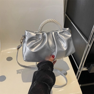 Silver metallic pleated handbag with pearl handle and crossbody strap for elegant style