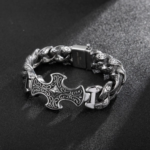 Close-up of retro cross engraved pattern on a silver stainless steel men's bracelet