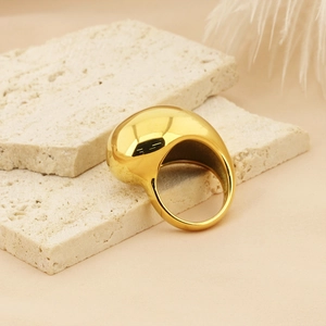 Minimalist chunky 18K gold plated titanium steel open ring on a textured stone board