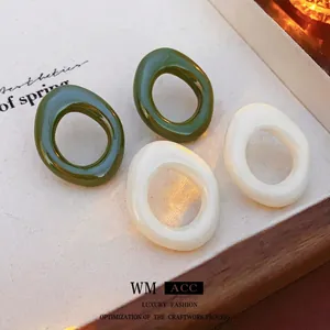 Minimalist resin hoop earrings in dark green and ivory white with a vintage gloss finish