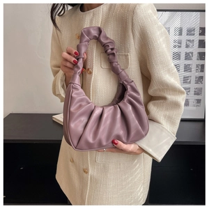 Detailed close-up of a purple pleated cloud bag with soft PU leather and twisted handle