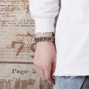 Detail of vintage silver skull pattern links on a thick stainless steel mens bracelet