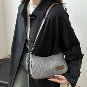 Chic grey woven underarm bag with brown leather straps and minimalist vintage design