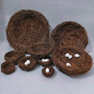 Detailed view of handcrafted rattan bird nests in various sizes with speckled faux eggs