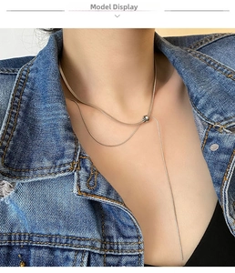 Detail of adjustable silver snake chain necklace with bolero slide clasp on model