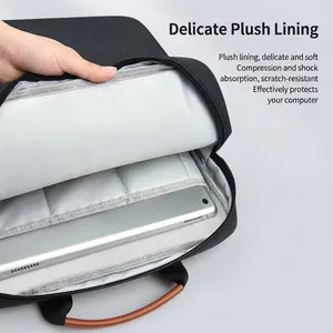 Black laptop sleeve with soft grey lining and brown leather handle for 14-inch laptops