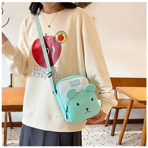 Detailed view of mint green cartoon bear crossbody bag with cute 3D ears and zipper