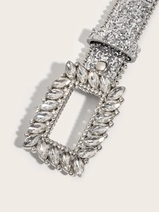 Detail of silver glitter belt with large rectangular rhinestone buckle and crystal accents