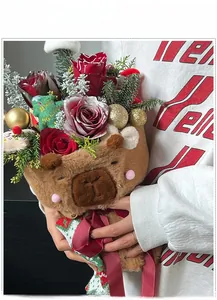 Close-up of a Christmas capybara plush bouquet with roses, pine needles and festive decor
