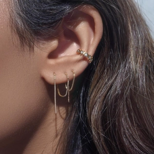 Detailed view of S925 silver gold chain earrings with star ear cuff on a model's ear