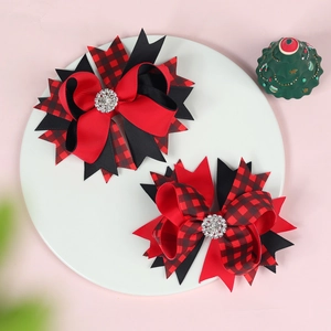 Detail of multi-layered Christmas bow hair clips with rhinestones and plaid ribbon patterns