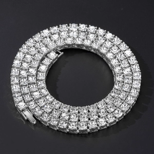 Detailed close-up of triple-row silver tennis chain with sparkling crystal zircons