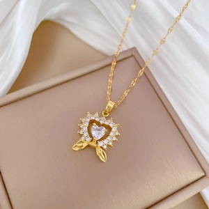 Luxurious gold heart pendant necklace with shimmering crystals on elegant white silk fabric