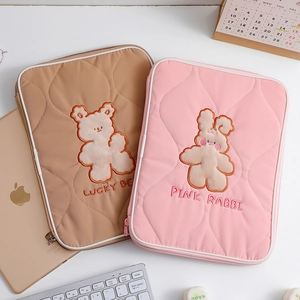 Detailed embroidery of Lucky Bear and Pink Rabbit on quilted tablet sleeve bags