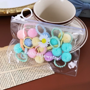 Gros plan d'élastiques à cheveux en peluche colorés dans une pochette zippée élégante