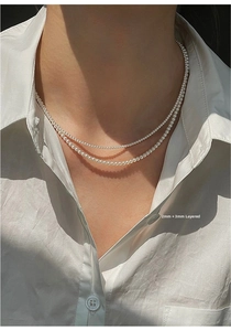 Detail showing layered 2mm and 3mm freshwater baby pearl necklaces with 14K gold accents