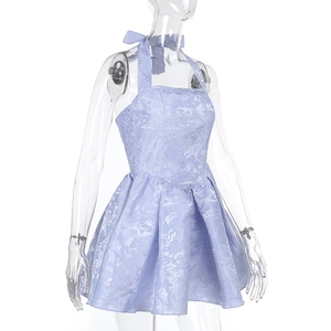 Detail of lavender floral jacquard fabric and halter neck bow on a slim fit dress