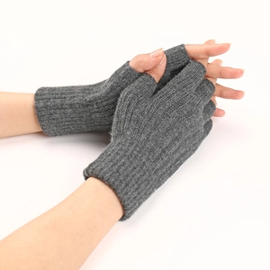 Close-up of gray cable-knit fingerless gloves for winter, showing warm texture and design