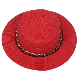 Detailed top view of red straw hat featuring a stylish gold chain and fine woven texture