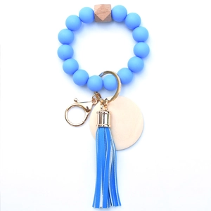 Detail of sky blue silicone beads with wooden hex bead and leather tassel keychain