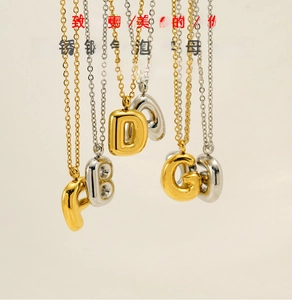 Vertical view of 3D bubble alphabet pendants in polished gold and silver finishes