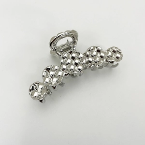 Macro shot of silver alloy shark hair clip featuring a polished woven texture design