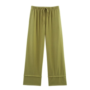 Detail of olive green wide-leg trousers with elastic drawstring waist and cuffed hem