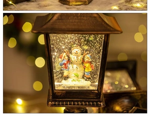 Close-up of a bronze Christmas lantern with a snowman and kids under warm LED lighting