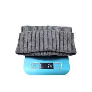 Classic grey ribbed knit beanie weighing approximately 74g on a blue digital scale