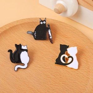 Cartoon black and white cat enamel pins set with punk style hugging feline designs