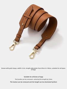 Close-up of 4.1cm wide brown litchi leather strap with adjustable gold clasps for bags