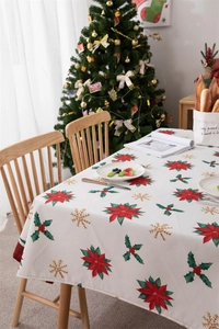 Detailed view of waterproof polyester tablecloth with festive poinsettia and holly prints