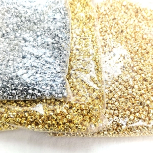 14k gold-filled crimp beads for jewelry making in gold and silver finish on white background