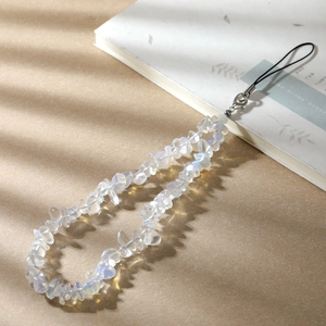 Detail of a natural crystal stone phone strap with iridescent beads and silver clasp