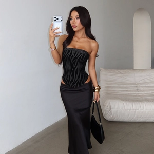 Close-up of zebra pattern corset top paired with black satin maxi skirt in mirror selfie