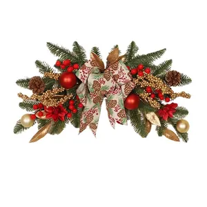 Red and gold Christmas door swag with pine cones, berries and burlap bow on white background