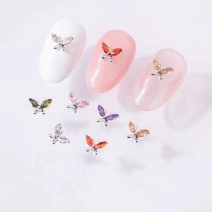 Detailed macro view of 3D alloy butterfly nail charms with colorful zircon inlays