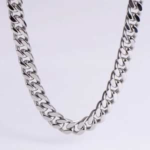 Close-up of highly polished silver stainless steel Cuban chain necklace links