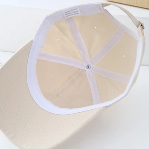 Detailed interior of a beige cotton baseball cap with sweatband and adjustable strap