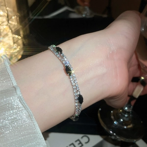 Close-up of luxury 18k gold plated double-layer zircon bracelet with black stones.