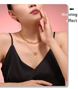 Wearing effect of layered heart pendant necklace with gold rings and colorful earrings