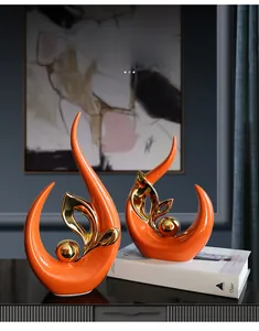 Modern abstract ceramic flame sculpture in bright orange and gold for home decor